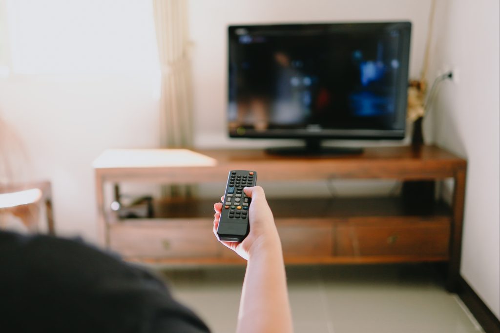 Watching Smart TV and Using Remote Controller Tv Hand Holding