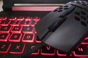 Perforated gaming mouse on the LED red gaming Keyboard