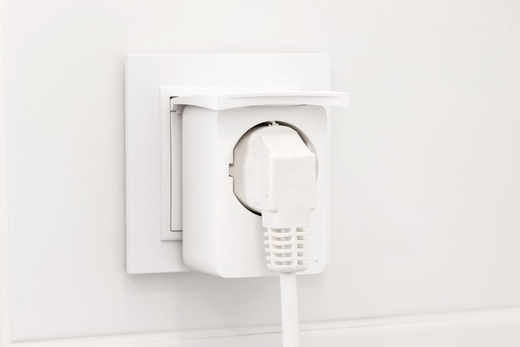 Electrical outlet with smart plug on modern bright bathroom